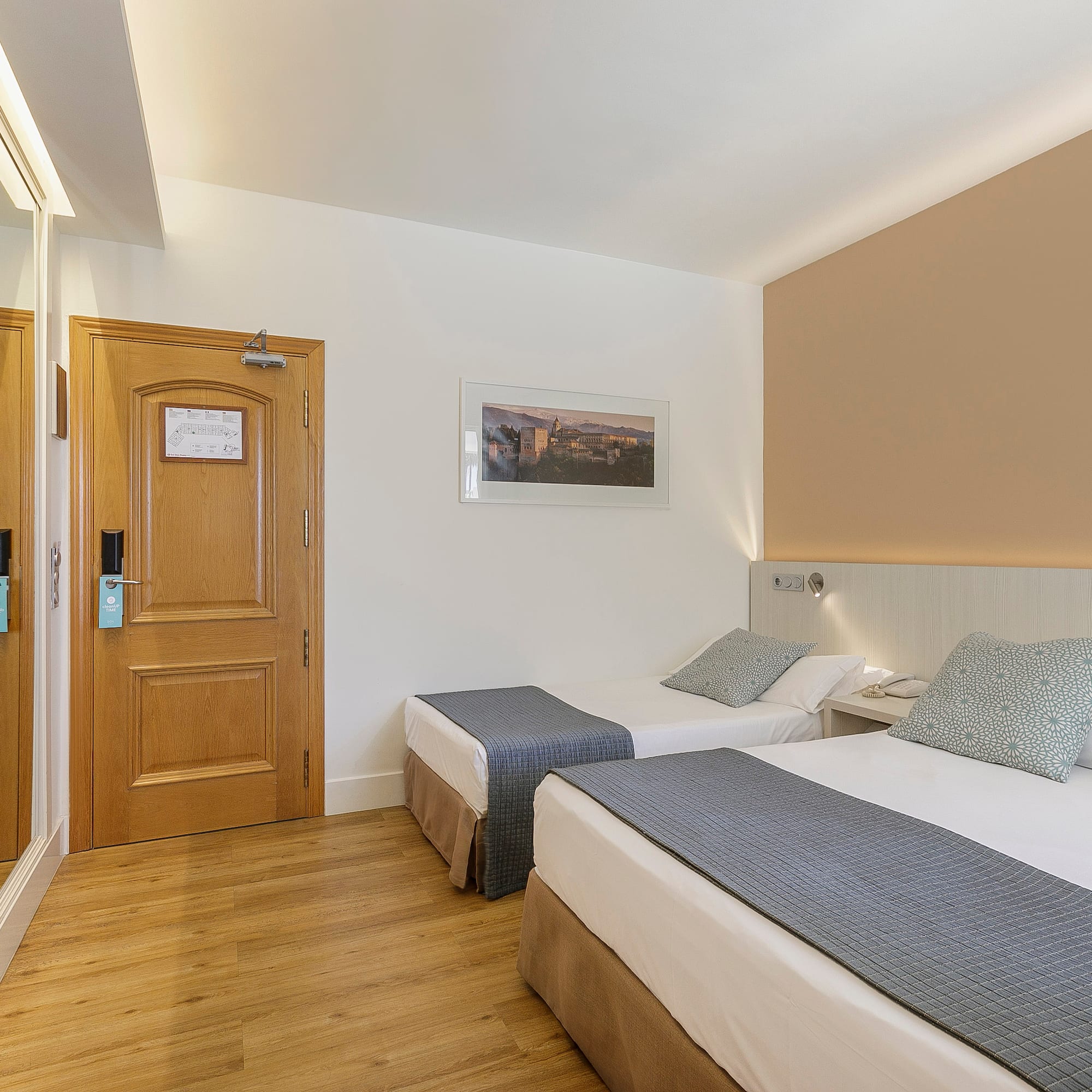 a room with two beds and a door