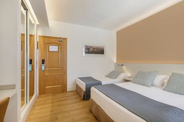 a room with two beds and a door