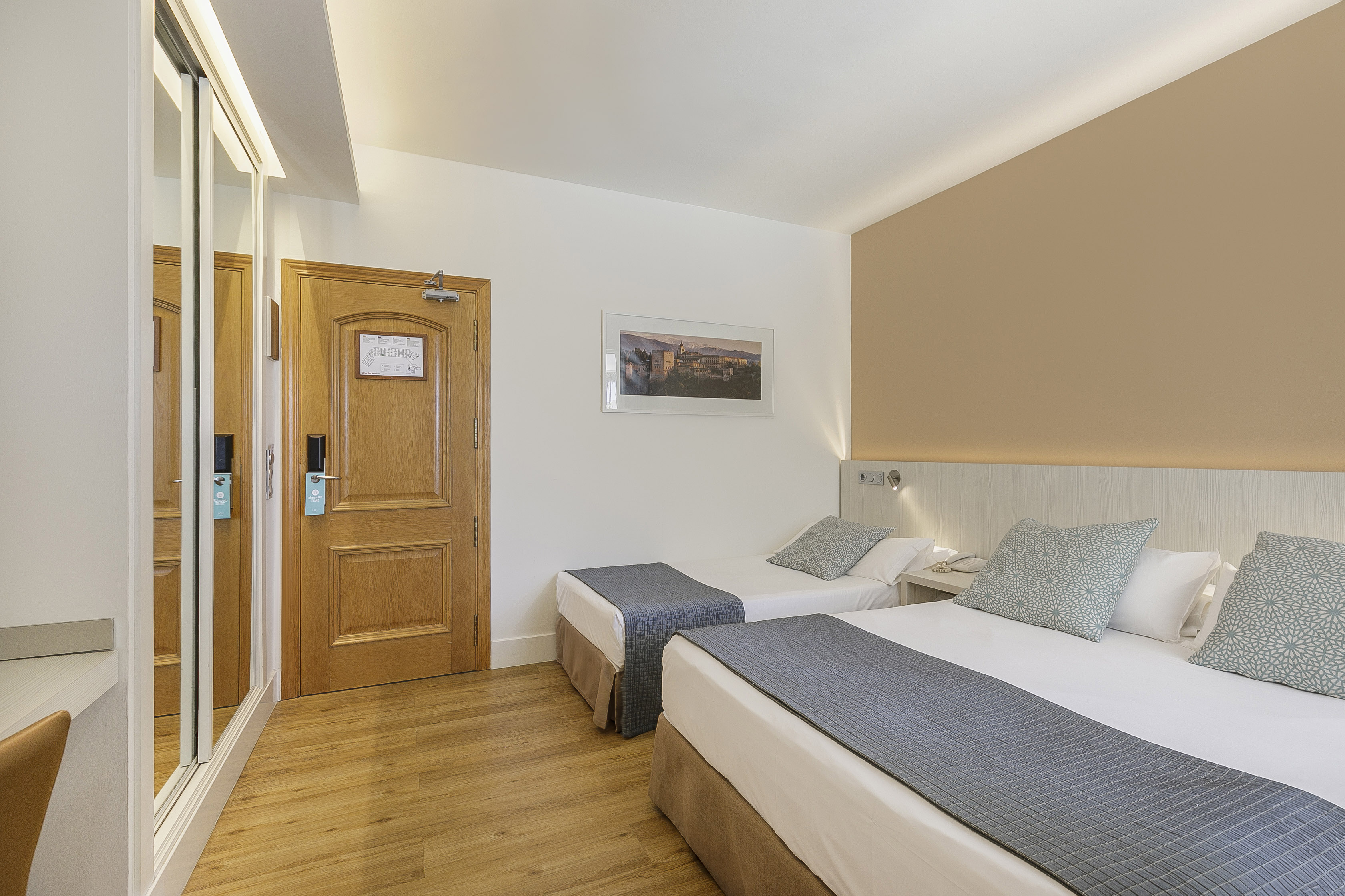 a room with two beds and a door