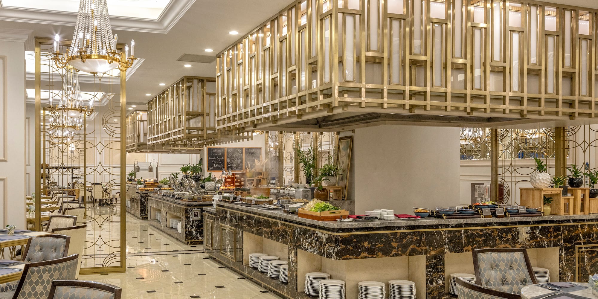 a restaurant with a large counter and a chandelier