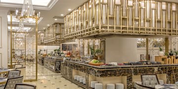 a restaurant with a large counter and a chandelier