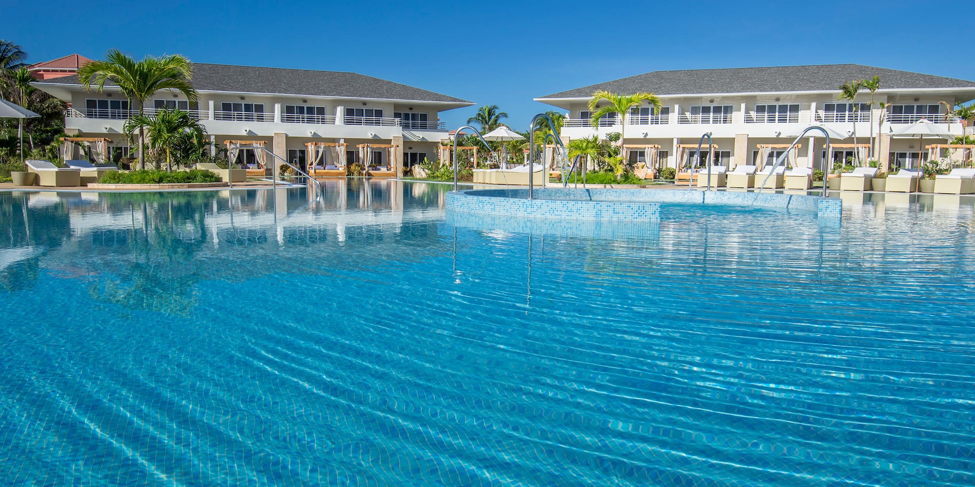 a swimming pool with buildings in the background