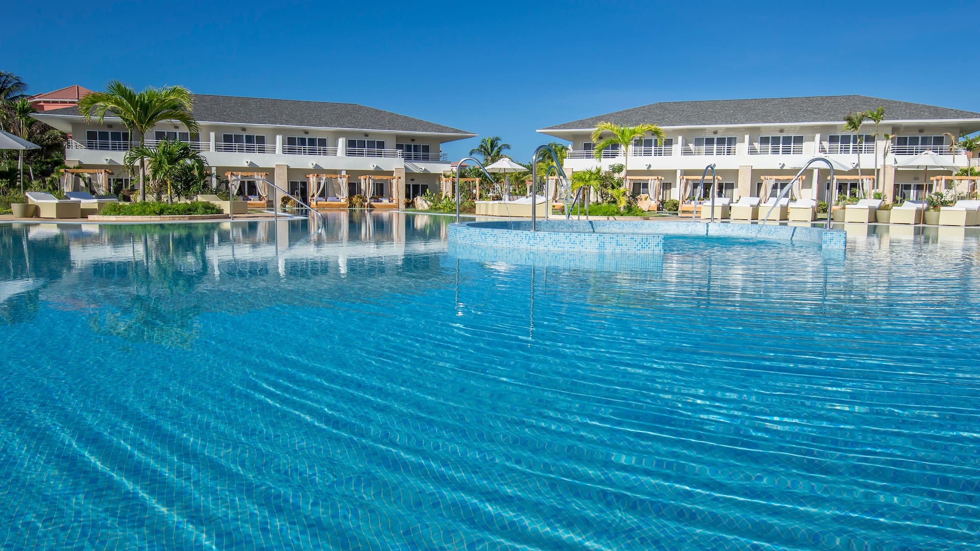 a swimming pool with buildings in the background