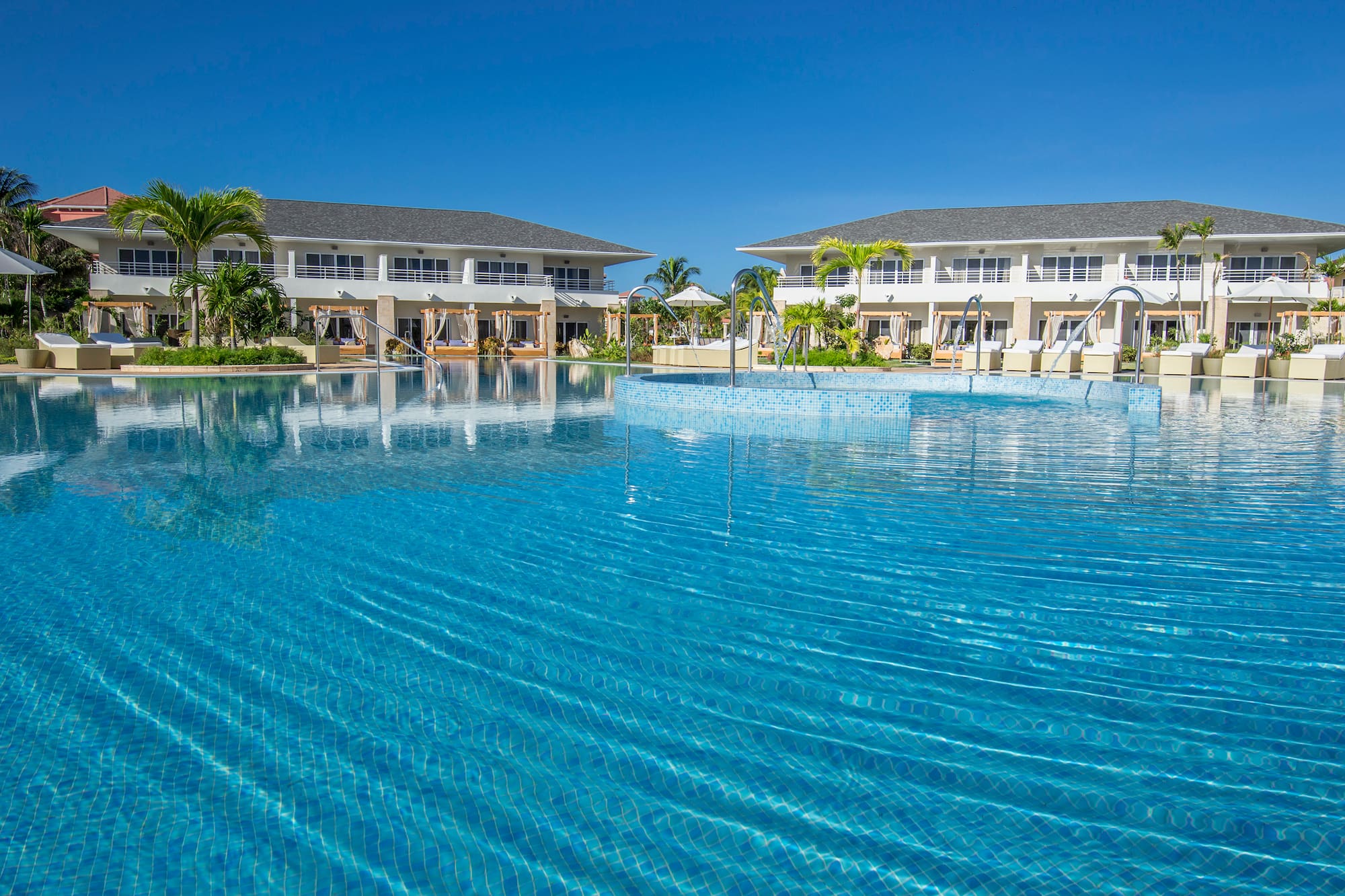 a swimming pool with buildings in the background