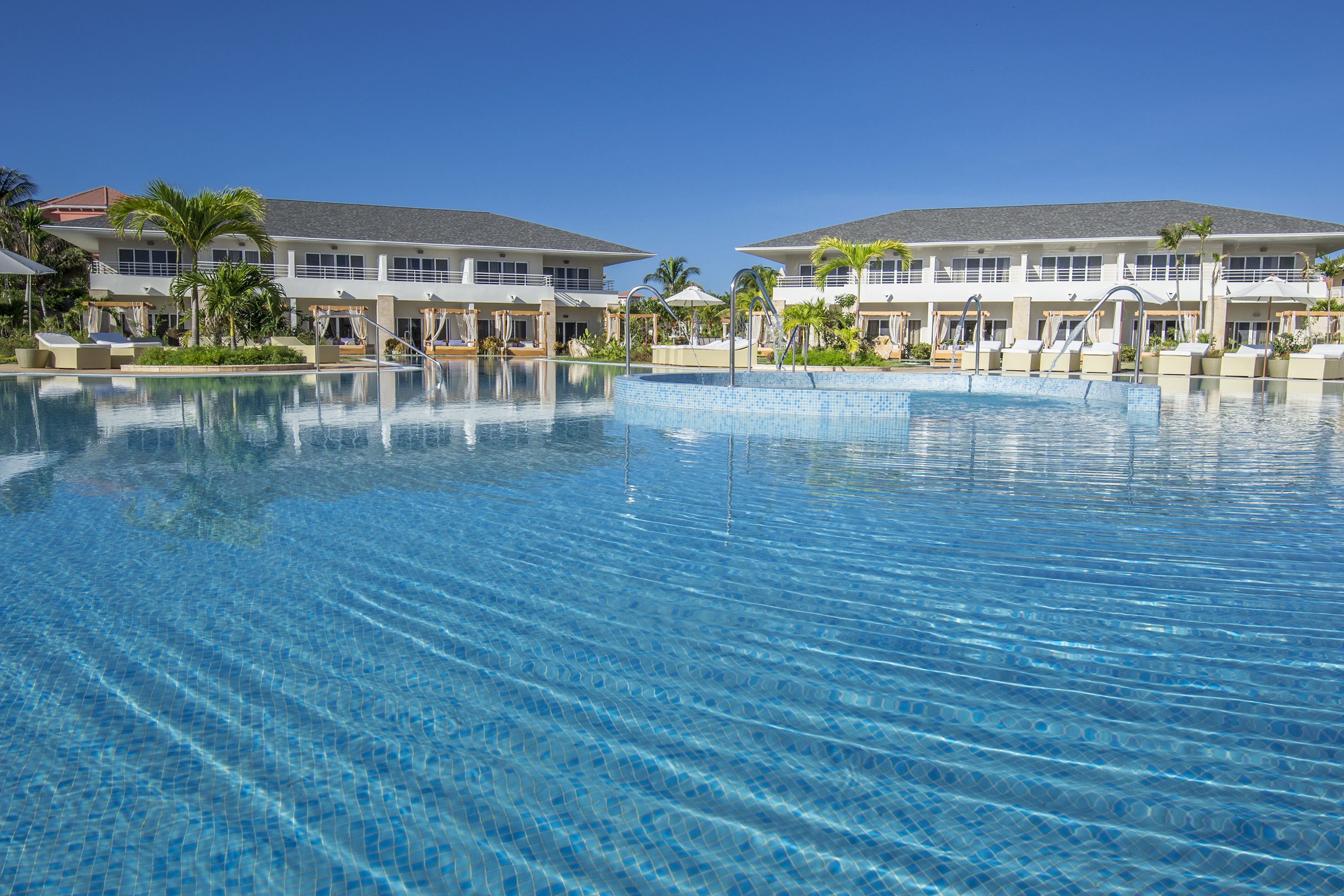 a swimming pool with buildings in the background