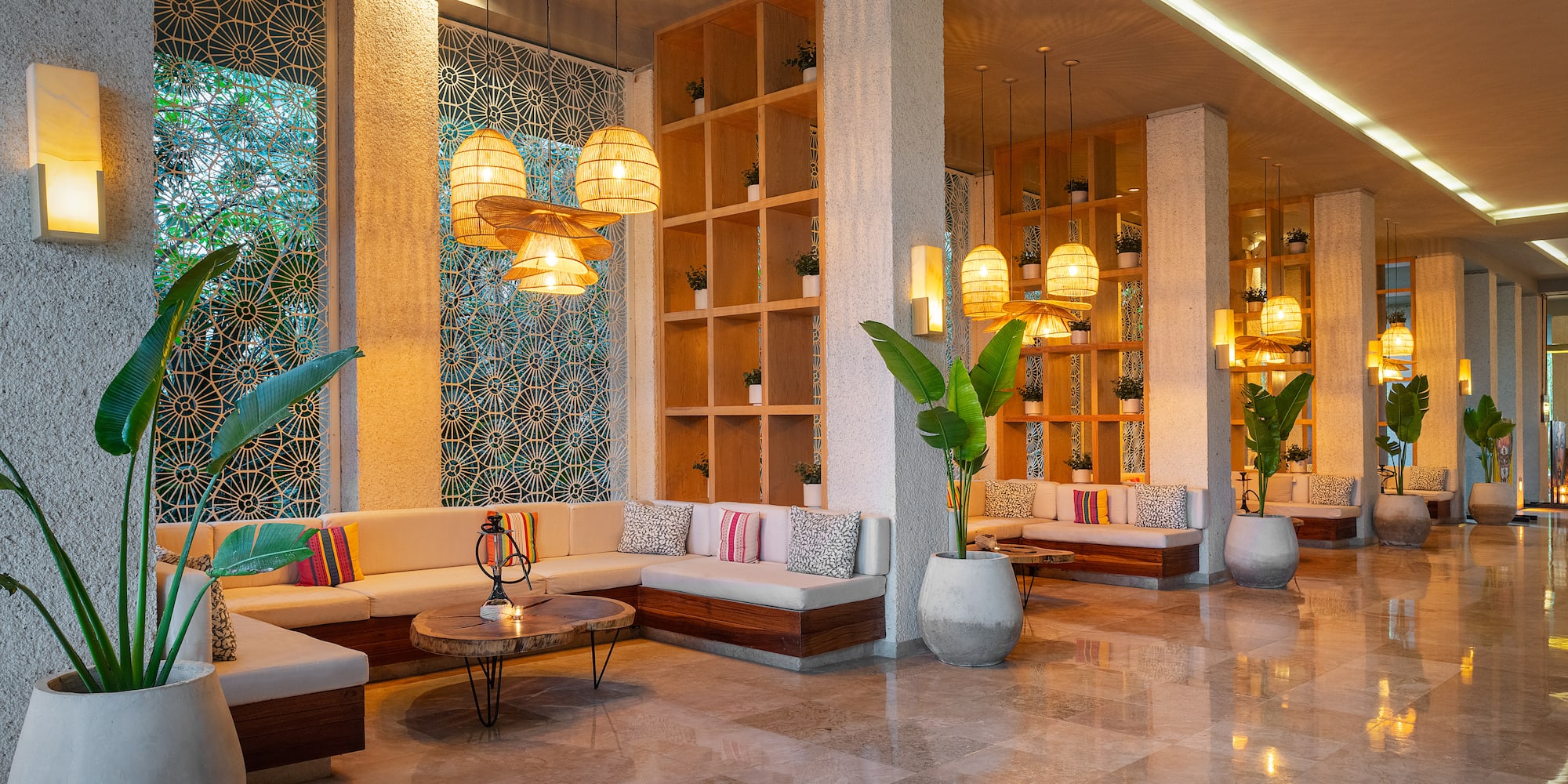 a room with a large couch and plants