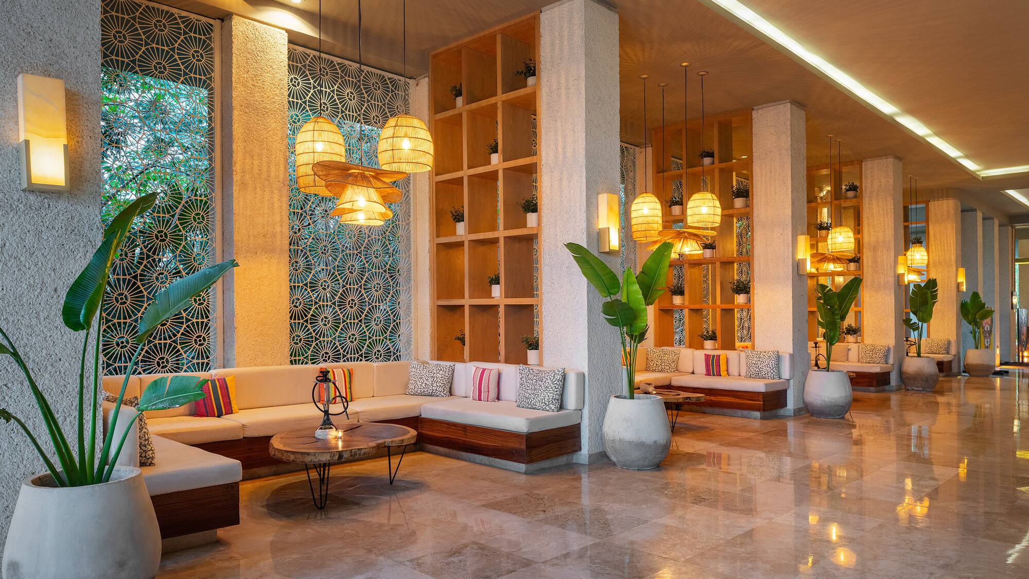 a room with a large couch and plants