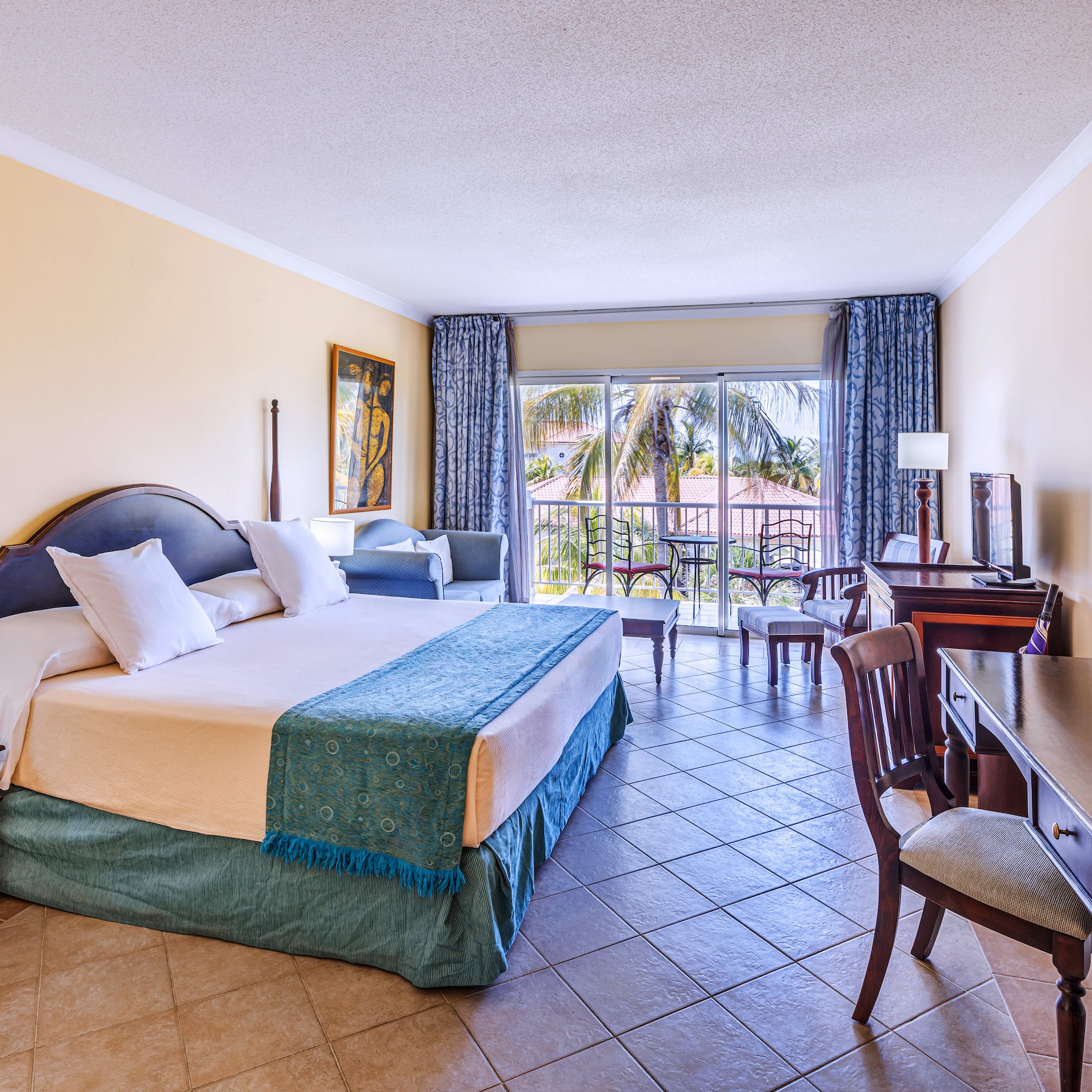 a room with a bed and a table and chairs