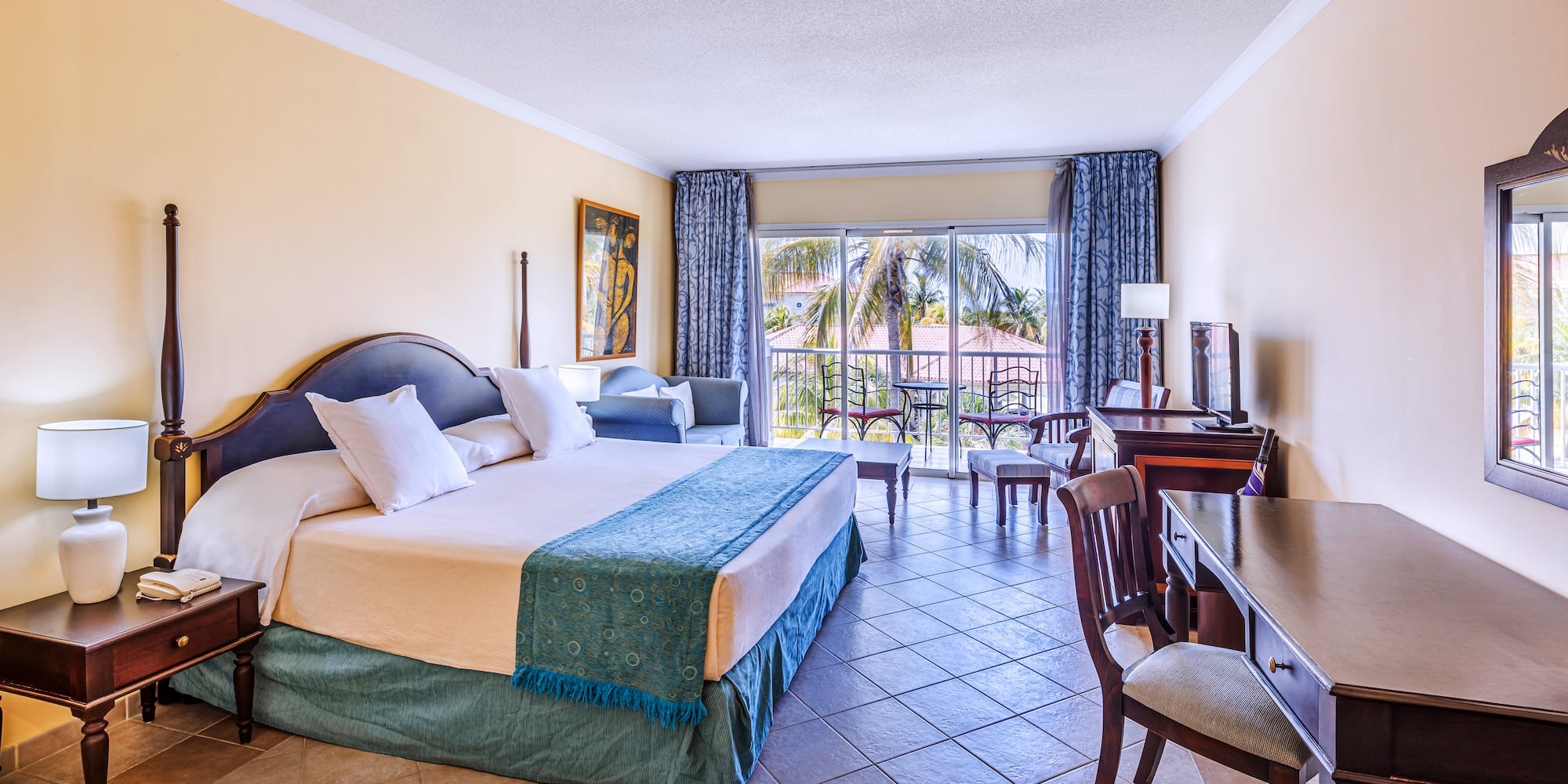 a room with a bed and a table and chairs