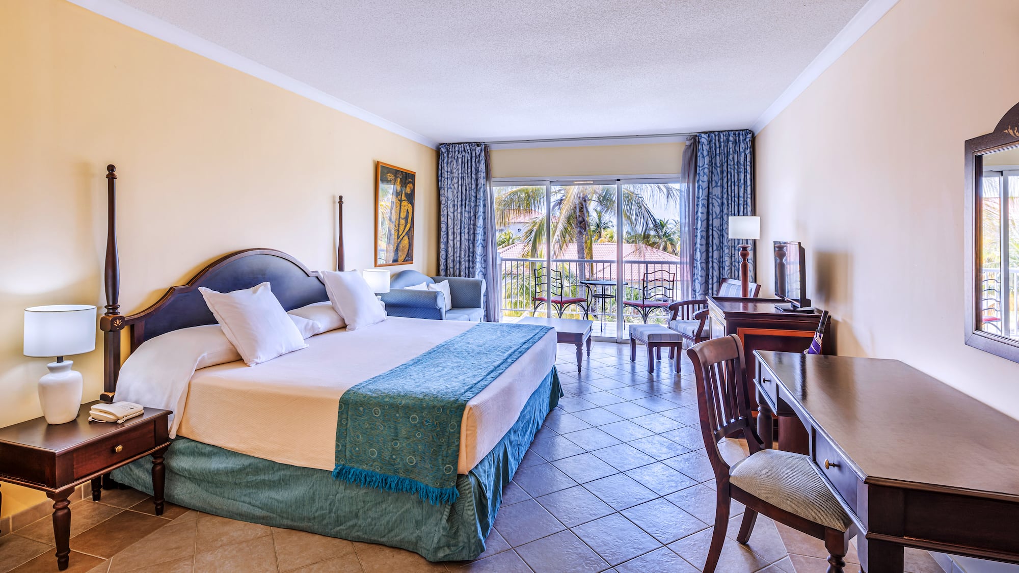 a room with a bed and a table and chairs