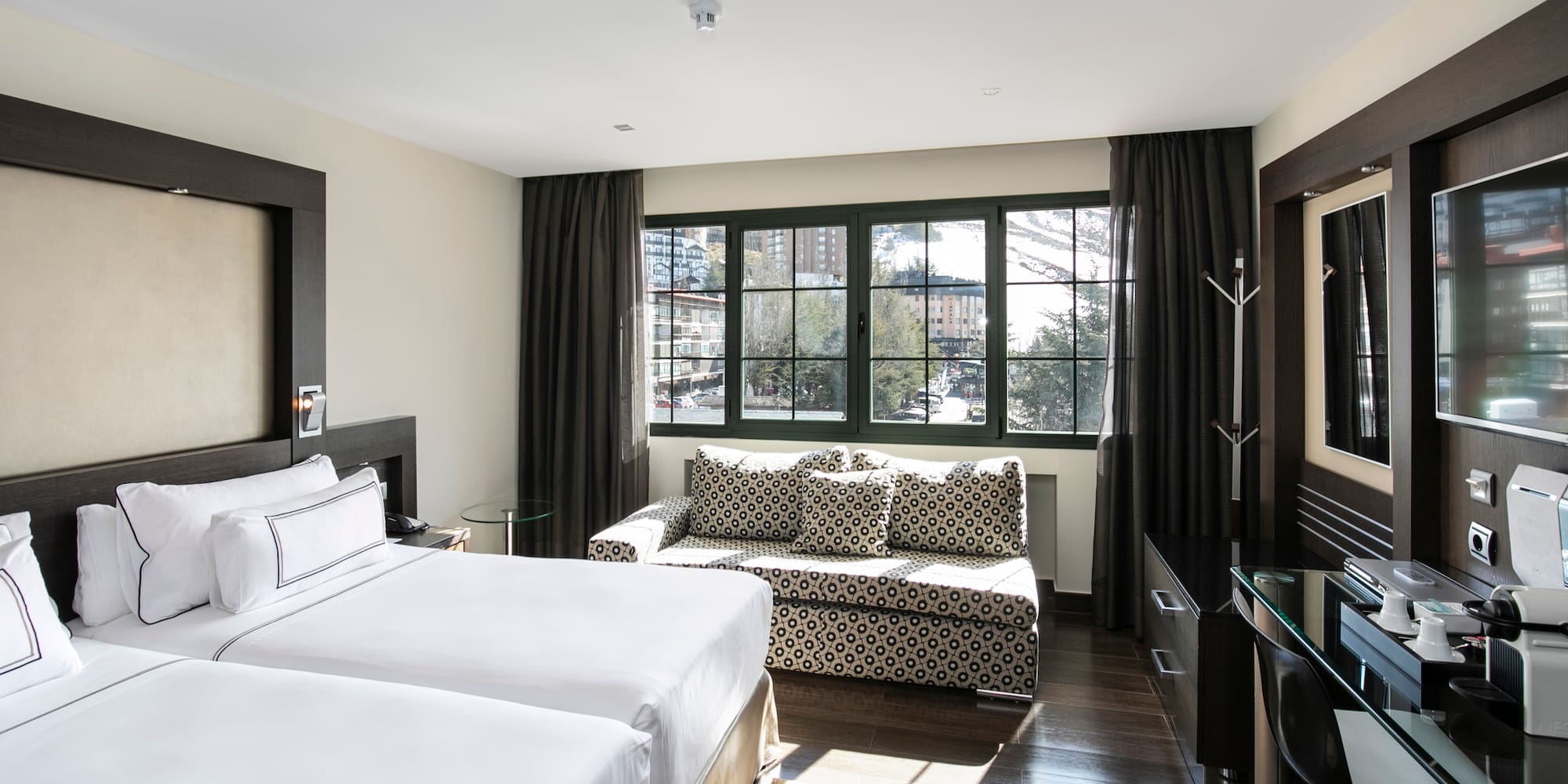 a room with two beds and a couch