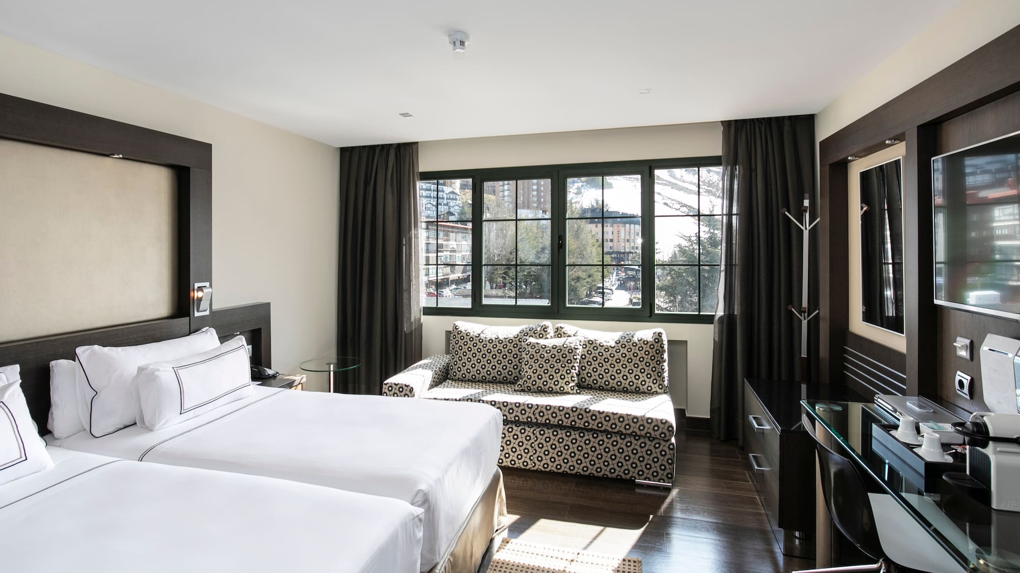 a room with two beds and a couch