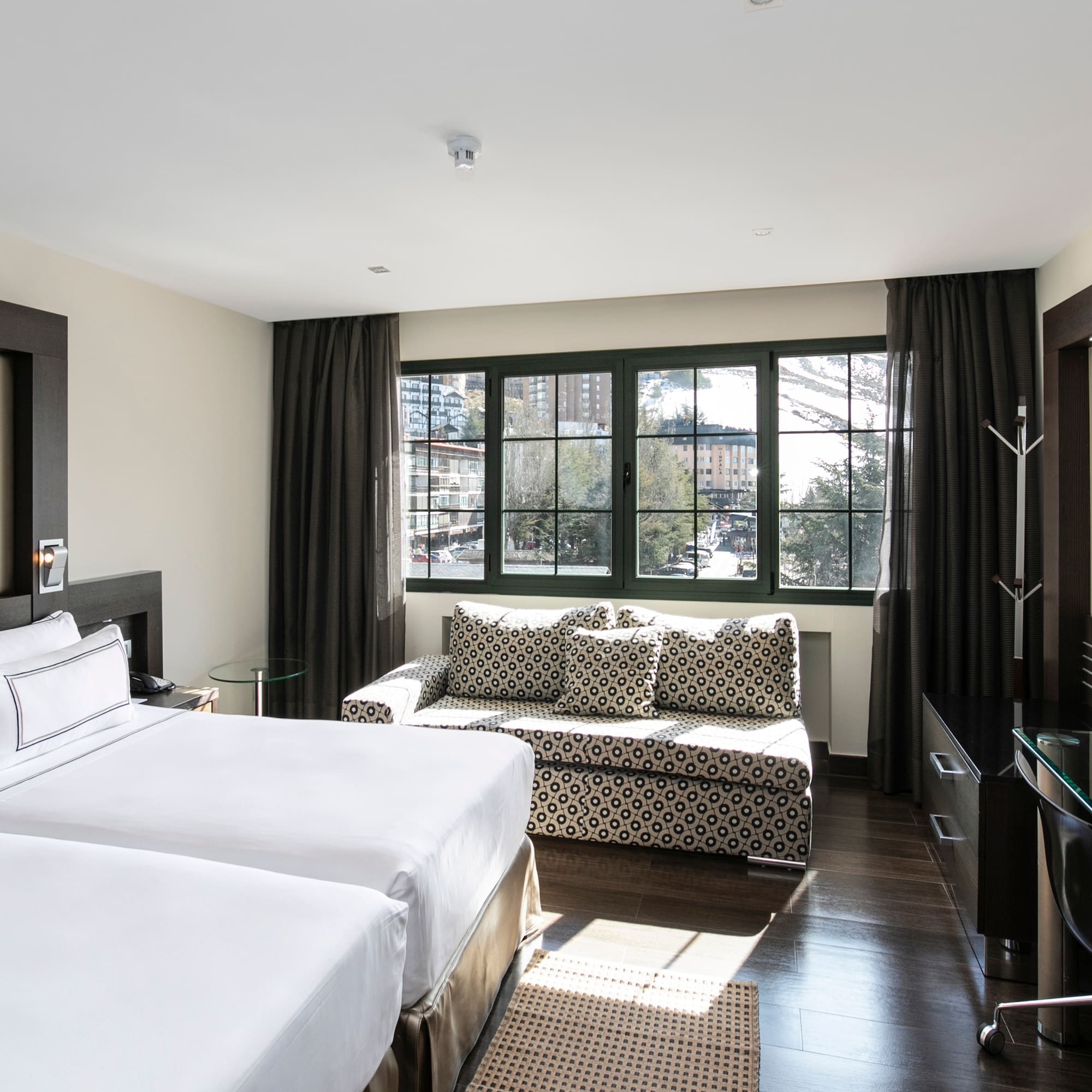 a room with two beds and a couch