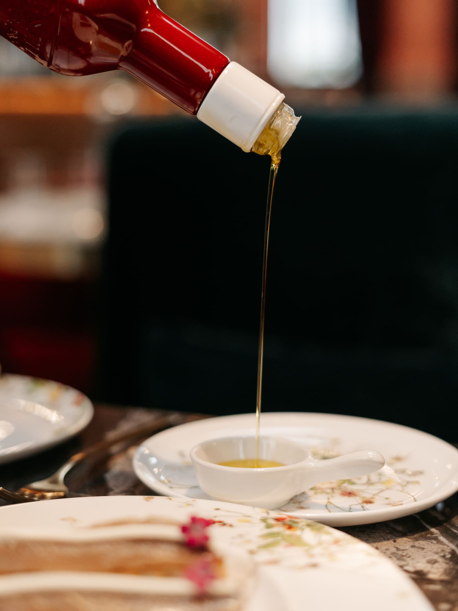 a sauce being poured into a small white cup