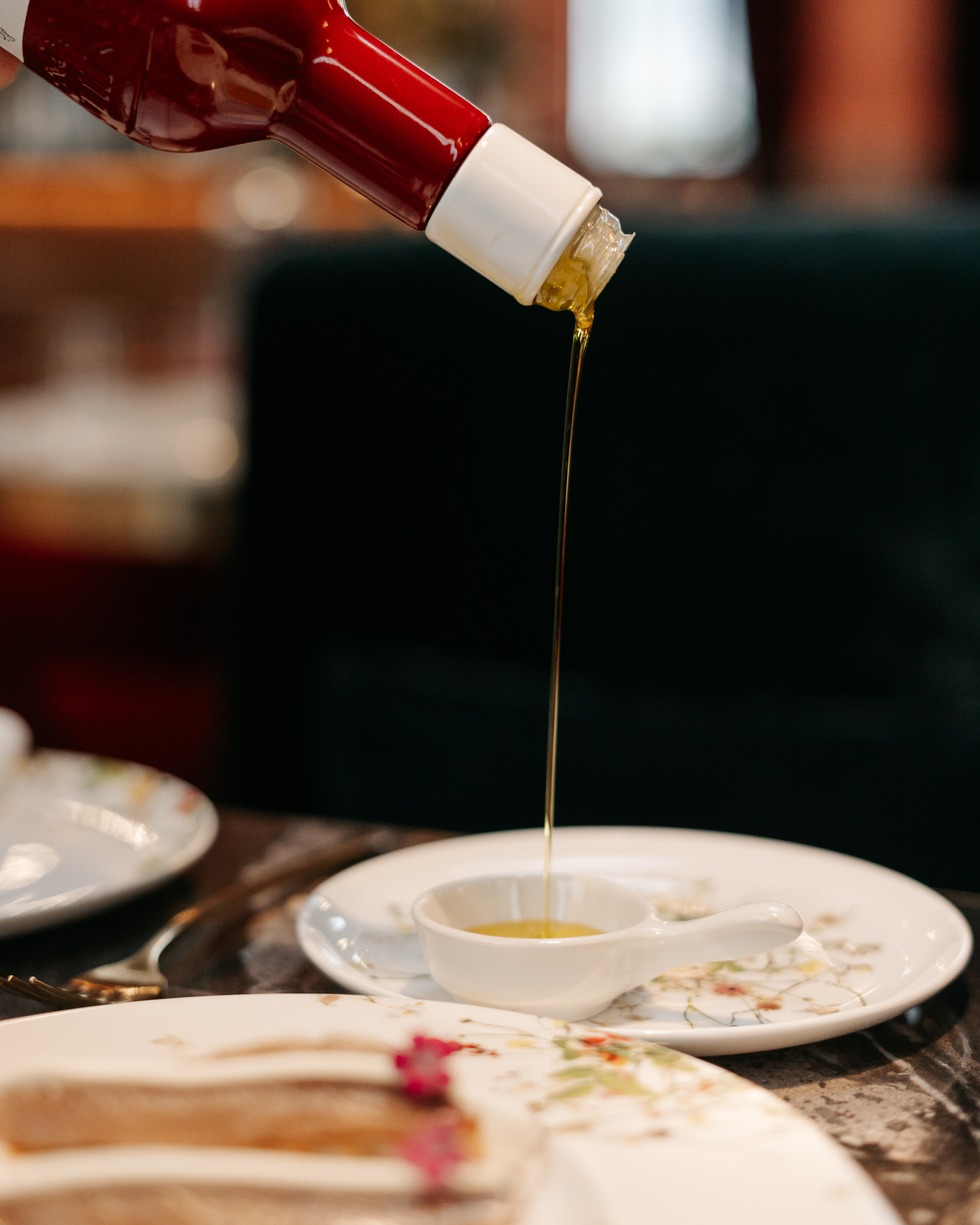 a sauce being poured into a small white cup
