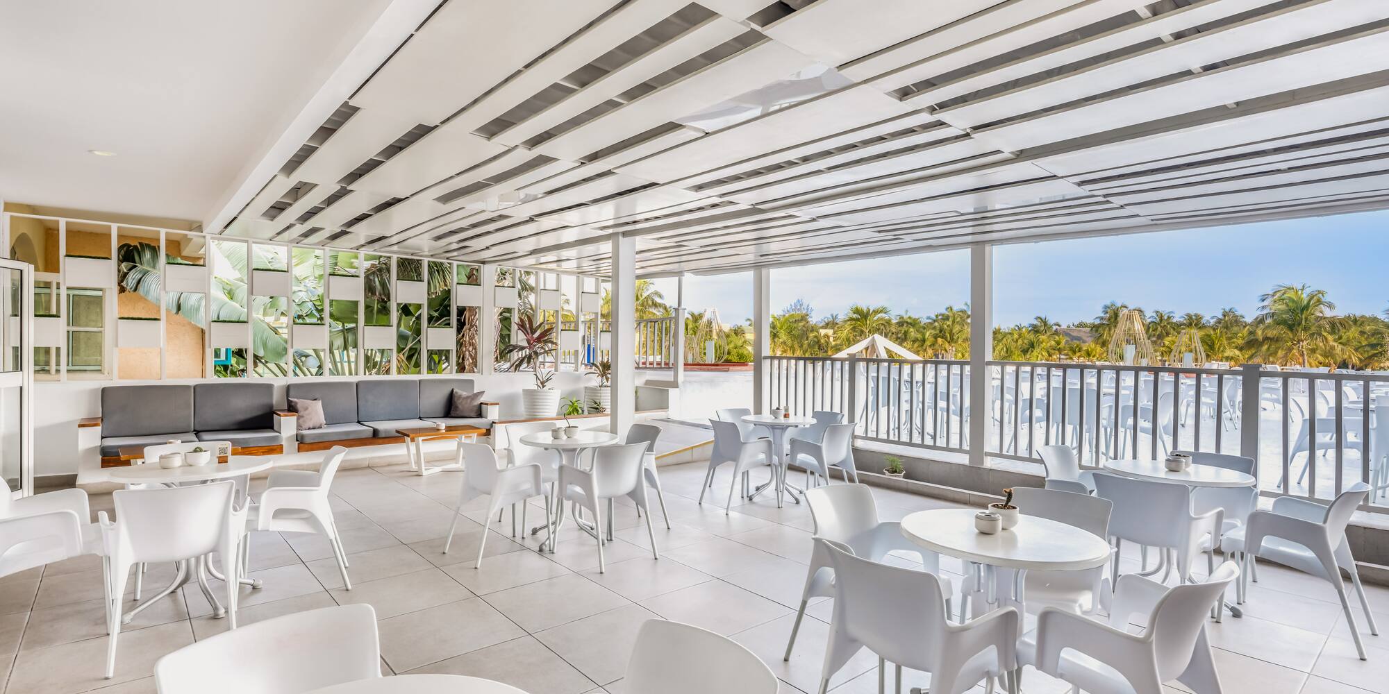 a white room with tables and chairs