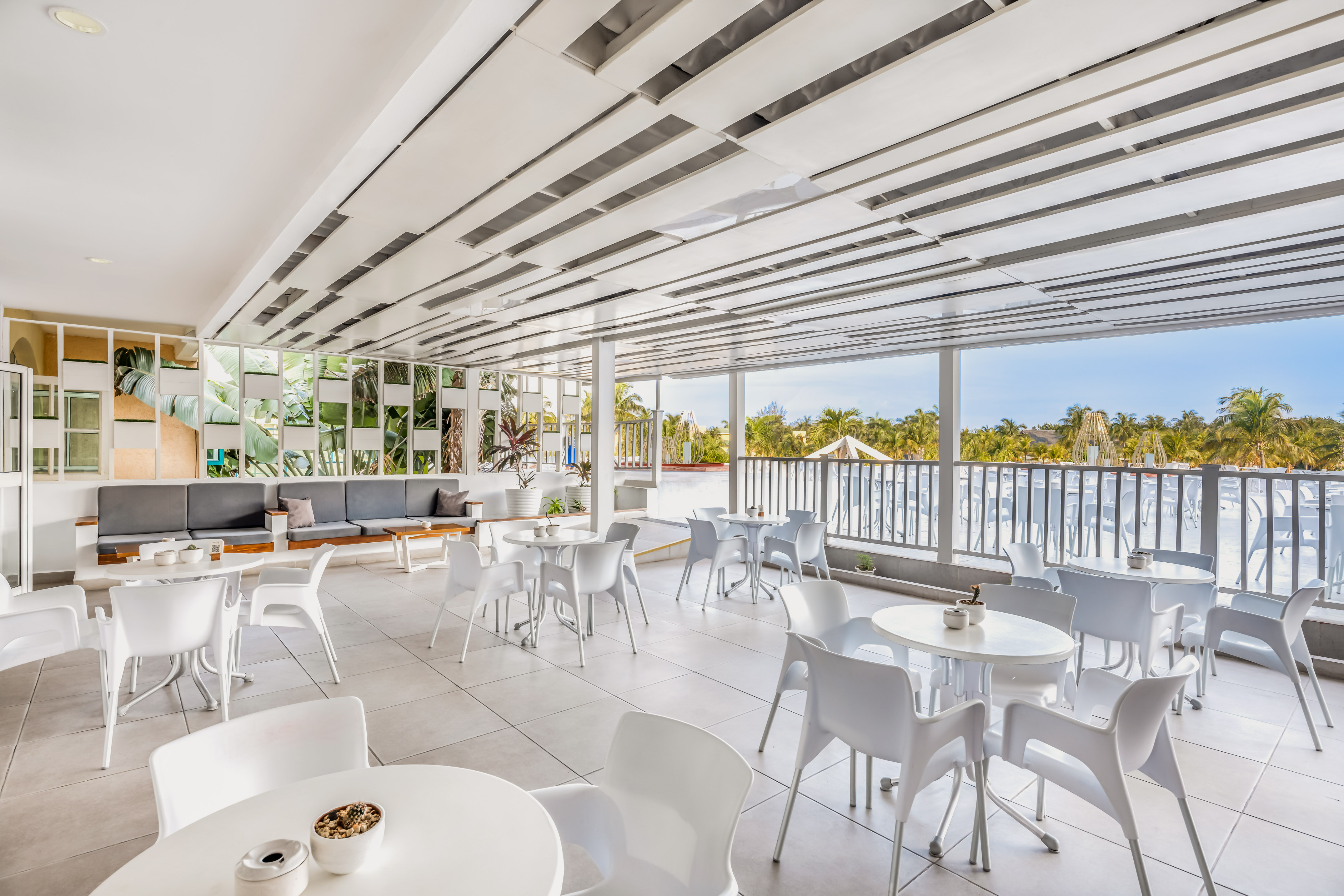 a white room with tables and chairs