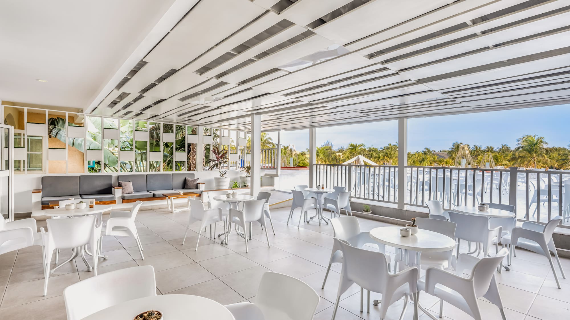 a white room with tables and chairs