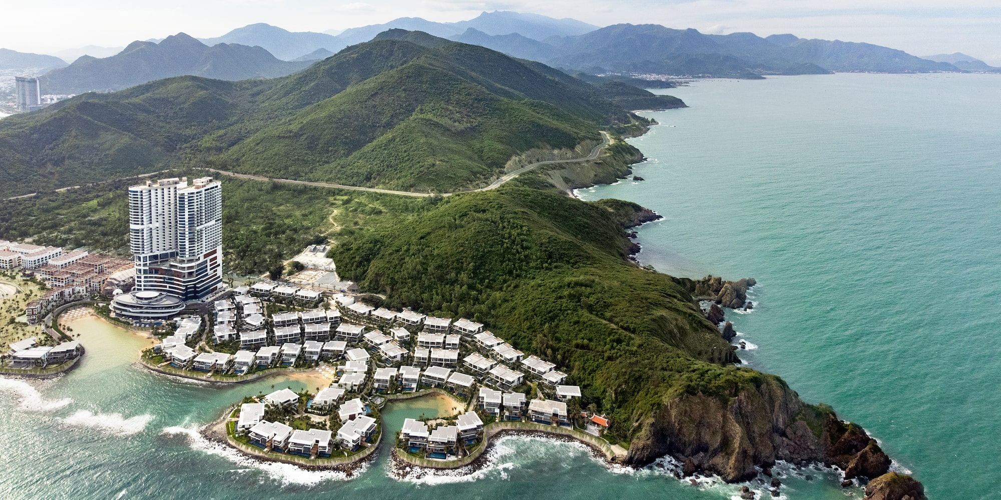 a building on an island surrounded by green hills