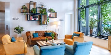 a room with a couch and chairs