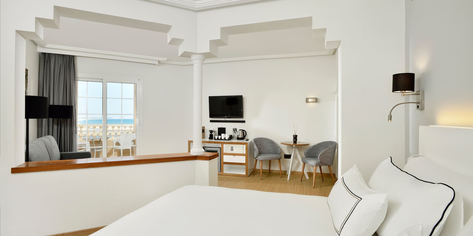 a room with a bed and a television