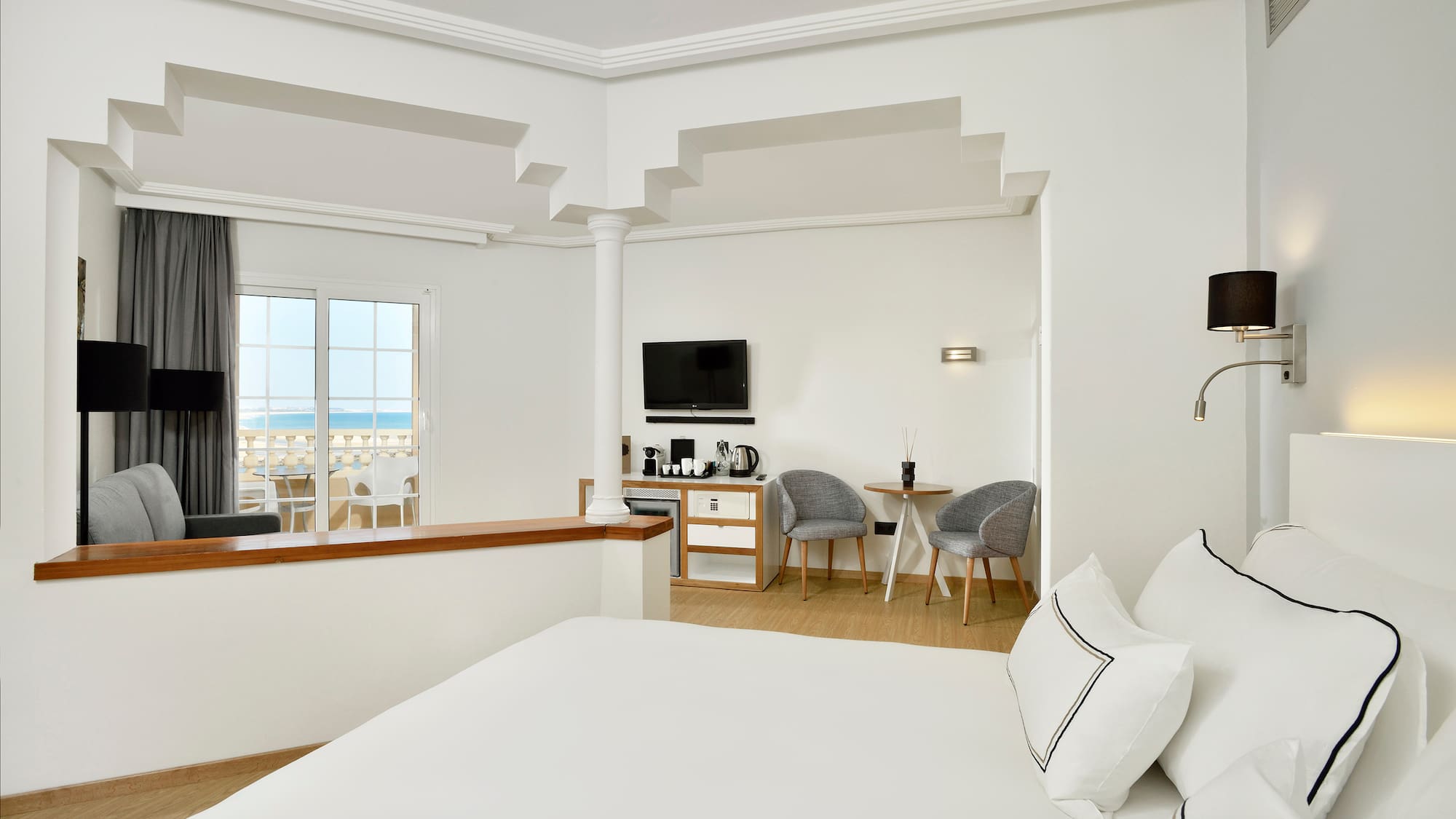 a room with a bed and a television