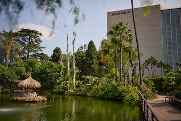 a body of water with trees and a building in the background