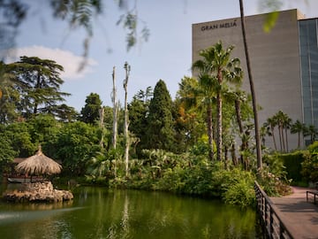 a body of water with trees and a building in the background