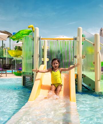 a girl in a yellow swimsuit on a water slide