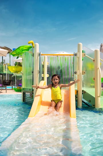 a girl in a yellow swimsuit on a water slide