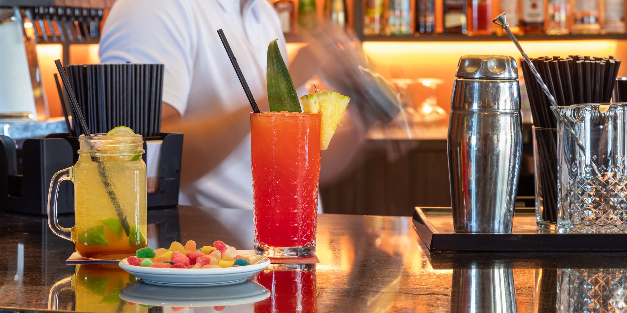 a man behind a bar with drinks