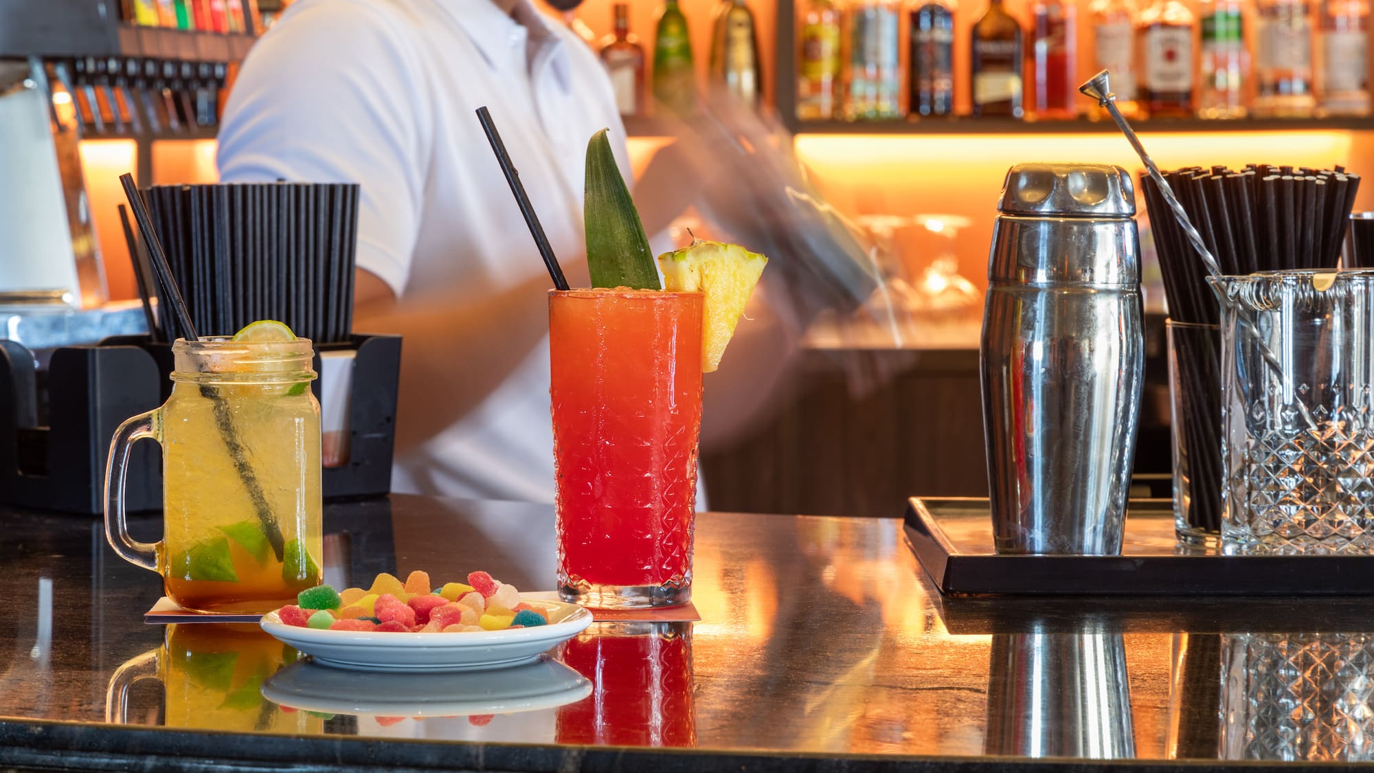 a man behind a bar with drinks