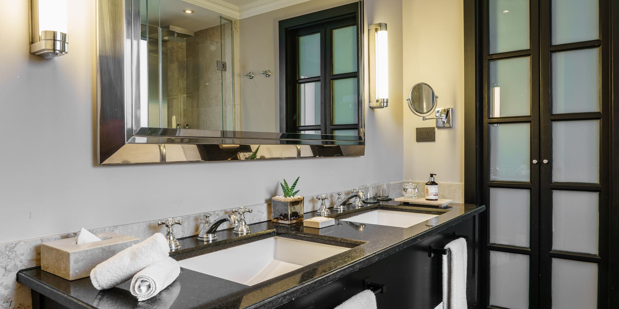 a bathroom with a large mirror and sinks