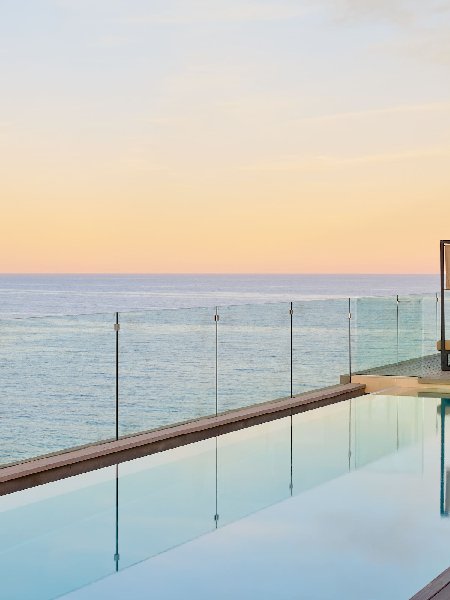 a pool with a deck and a deck overlooking the ocean