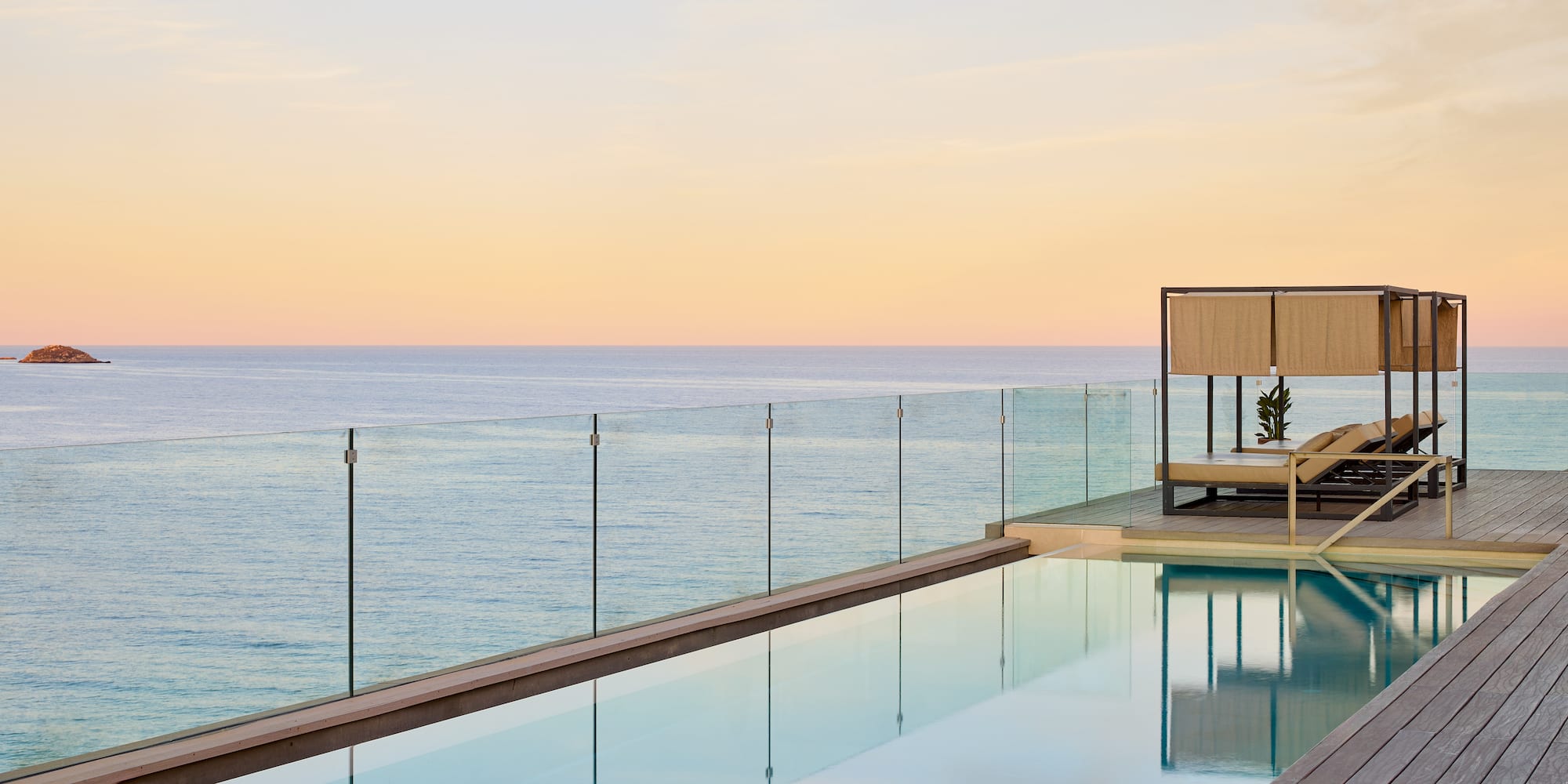 a pool with a deck and a deck overlooking the ocean