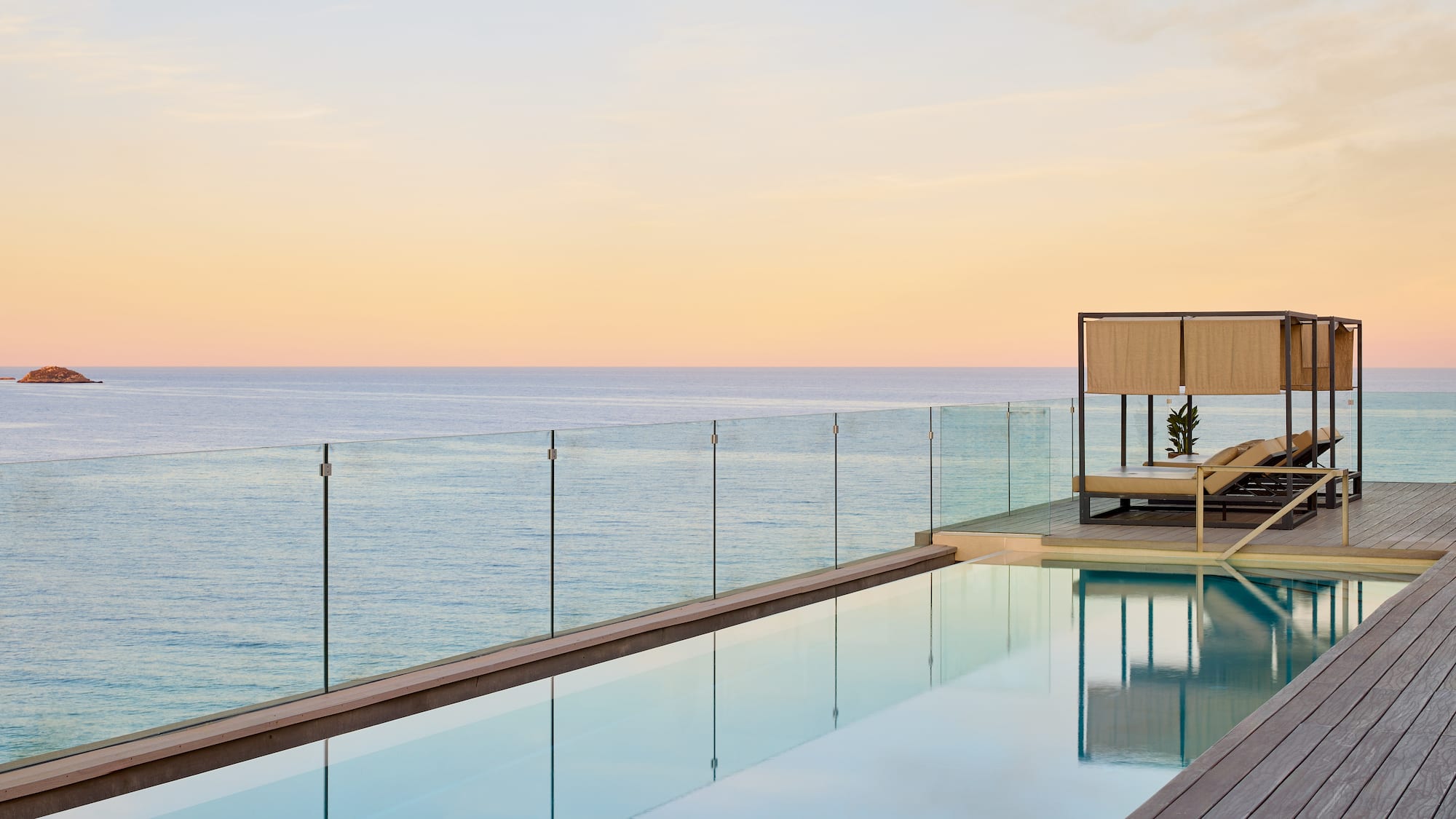 a pool with a deck and a deck overlooking the ocean