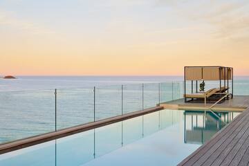 a pool with a deck and a deck overlooking the ocean
