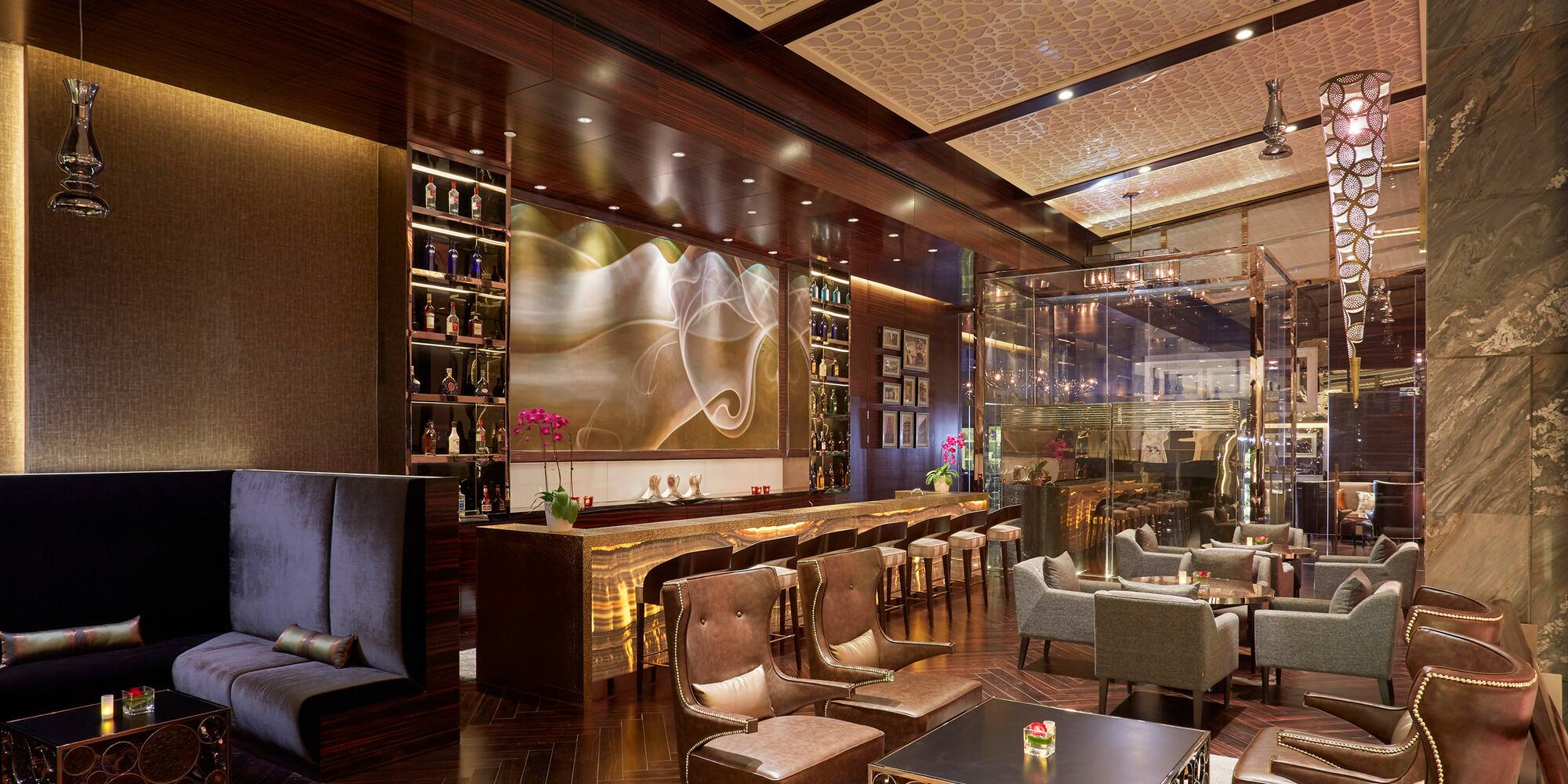 a room with a bar and chairs