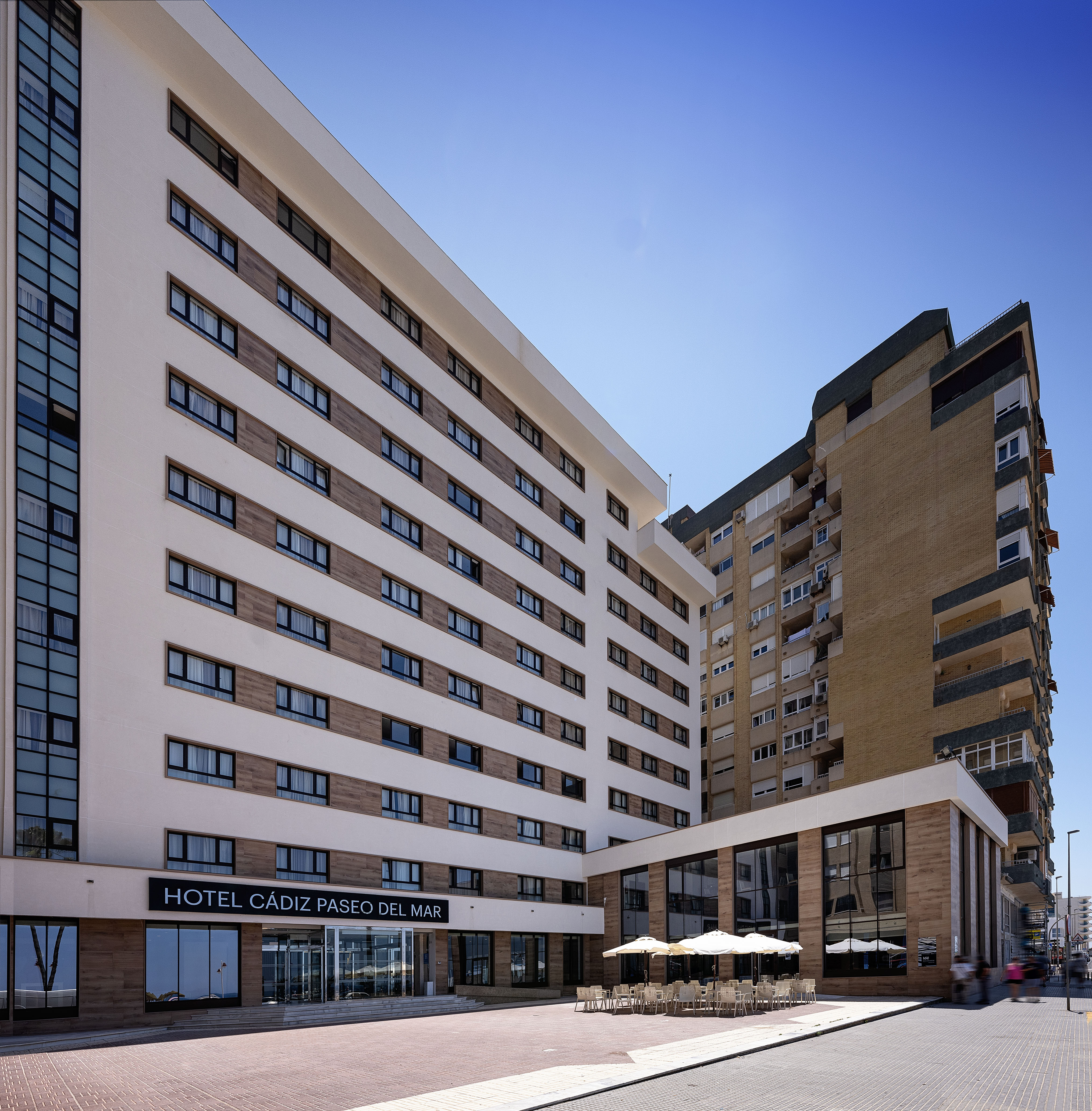 Hotel Cádiz Paseo del Mar exterior, modern white building with outdoor patio.