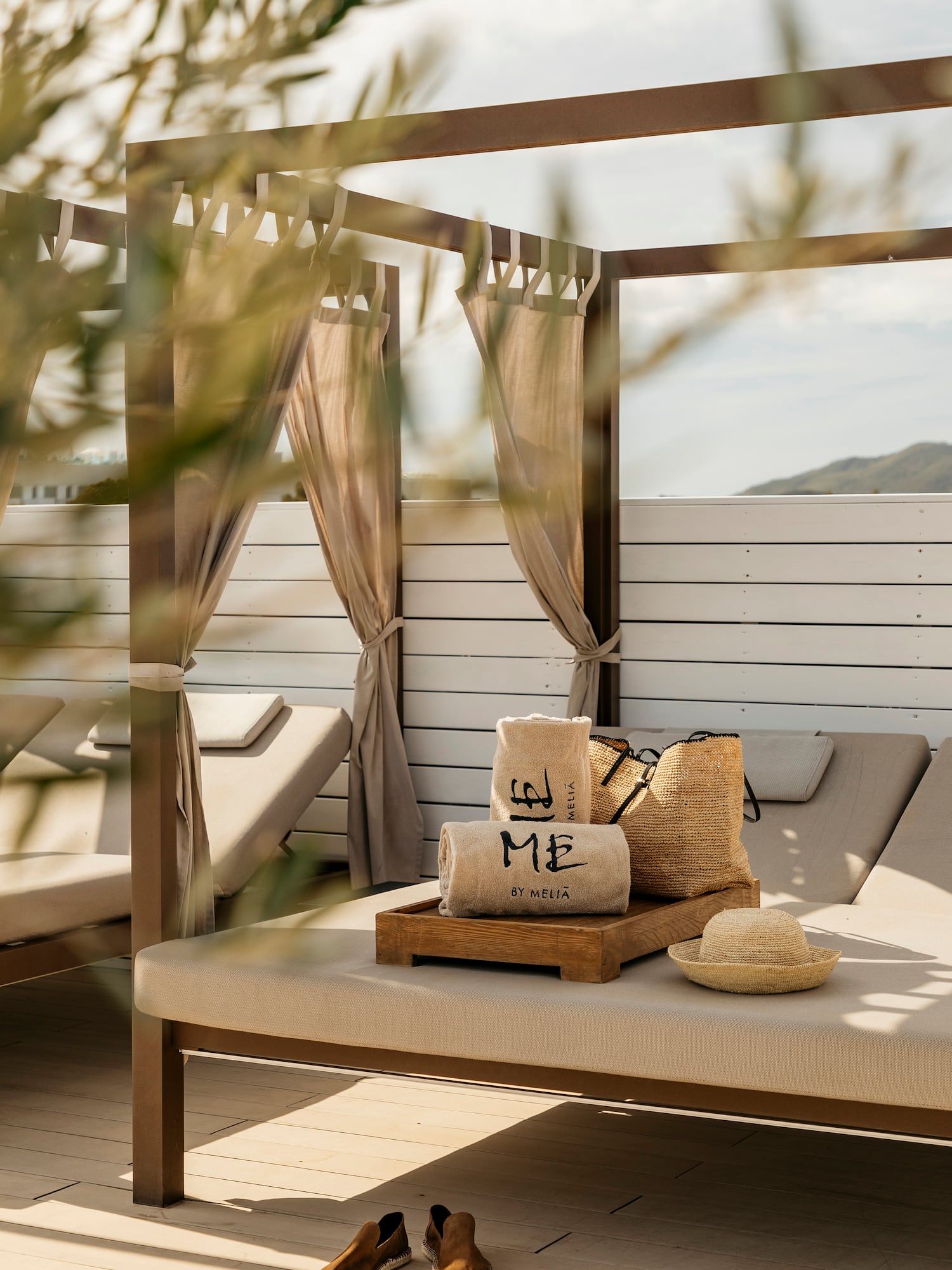 a lounge chair with a hat and bags on it