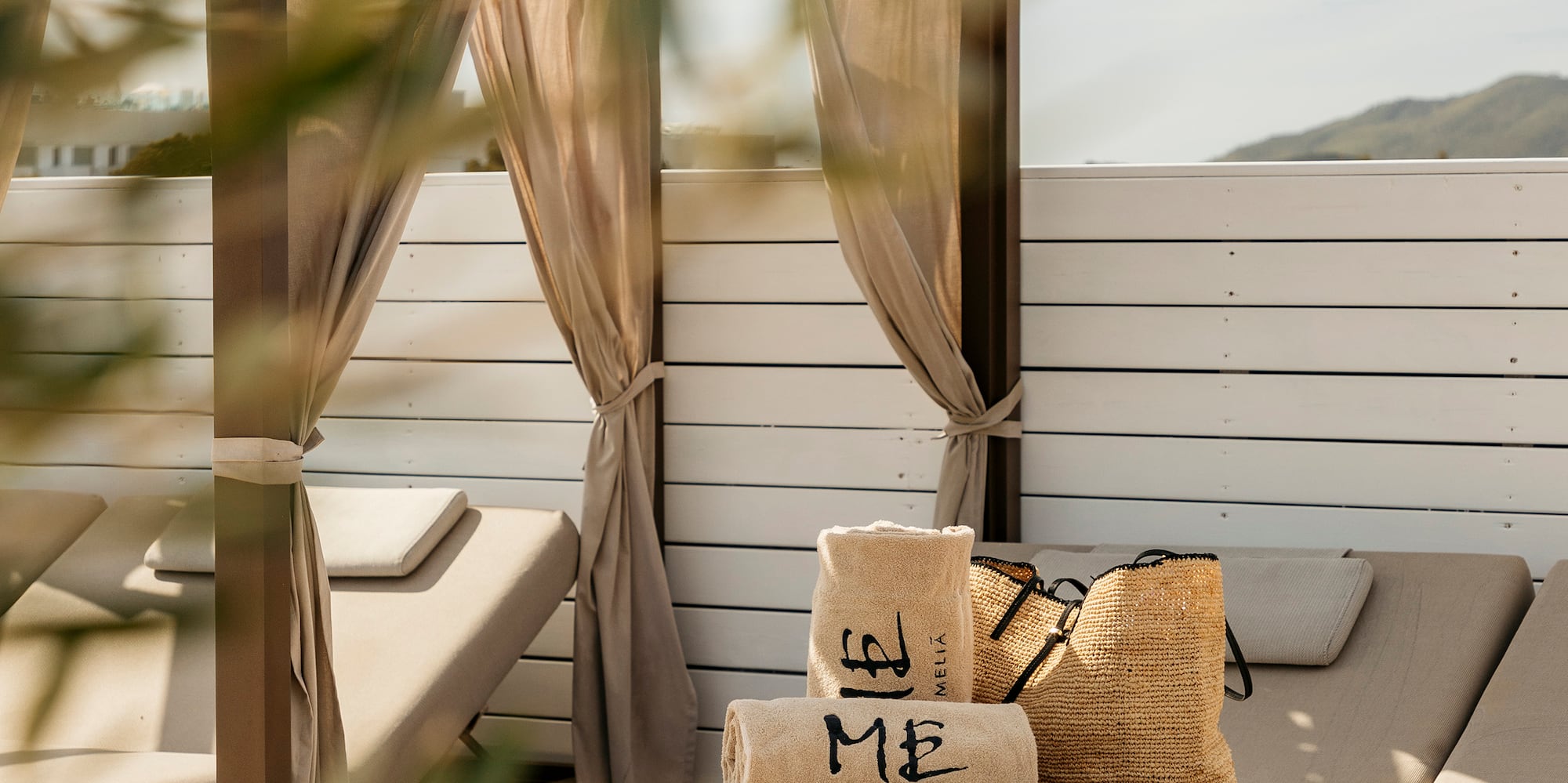 a lounge chair with a hat and bags on it