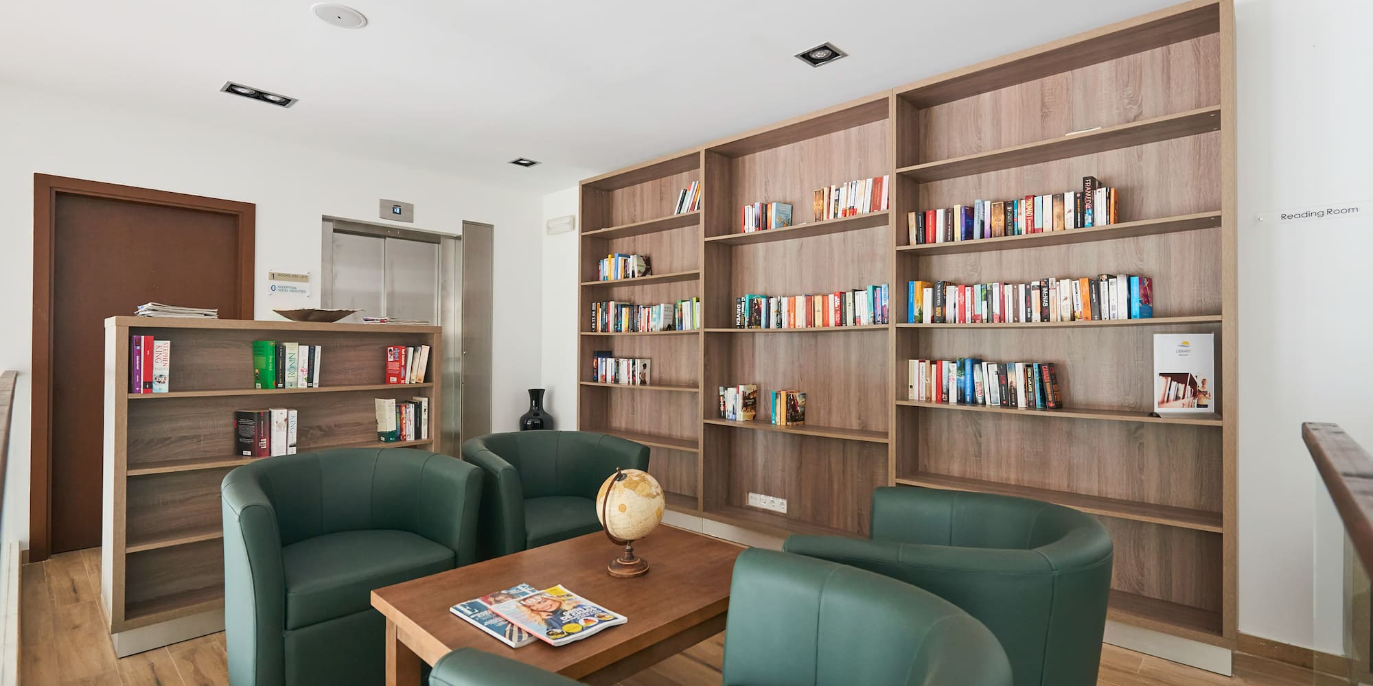 a room with a table and chairs and bookshelves