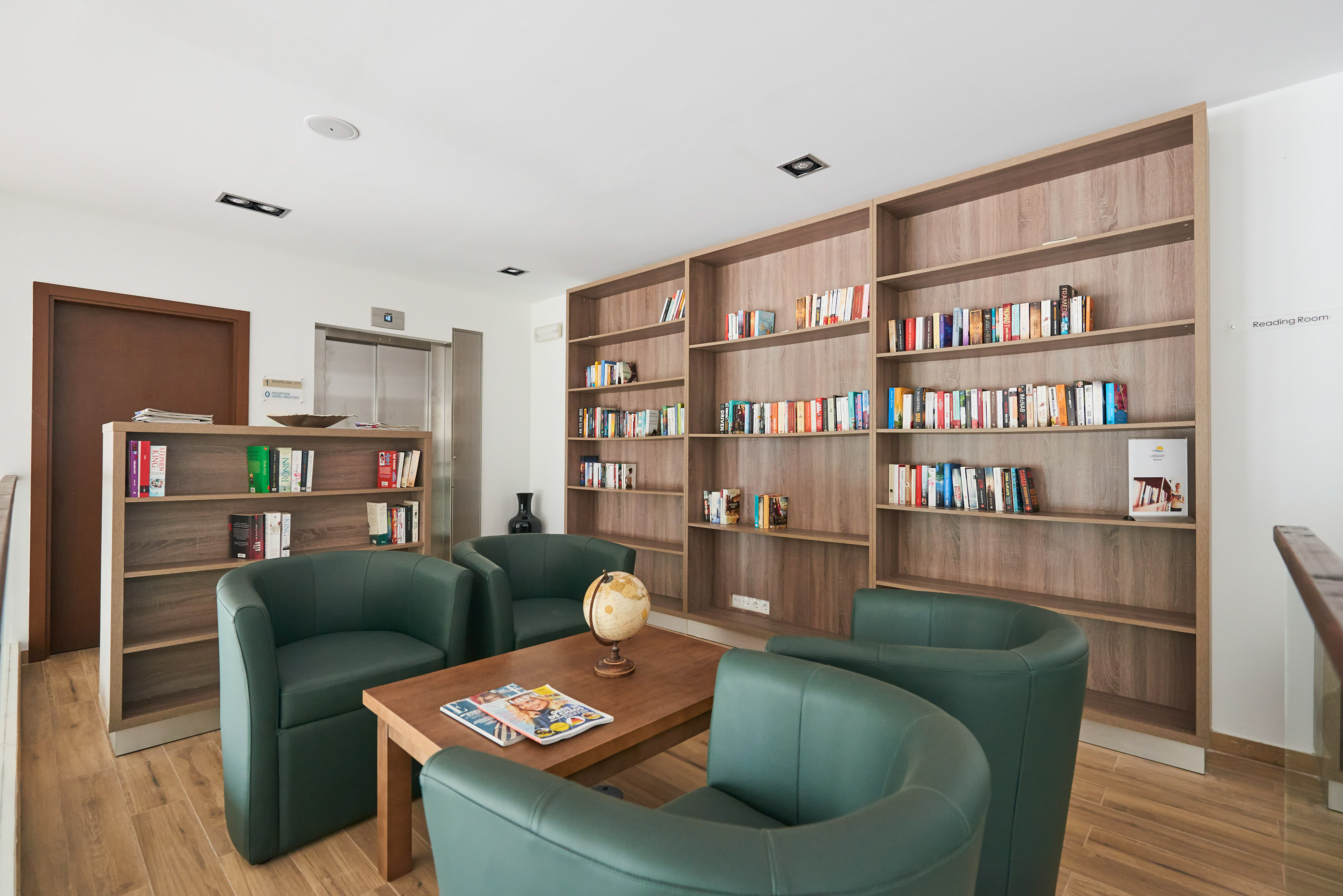 a room with a table and chairs and bookshelves