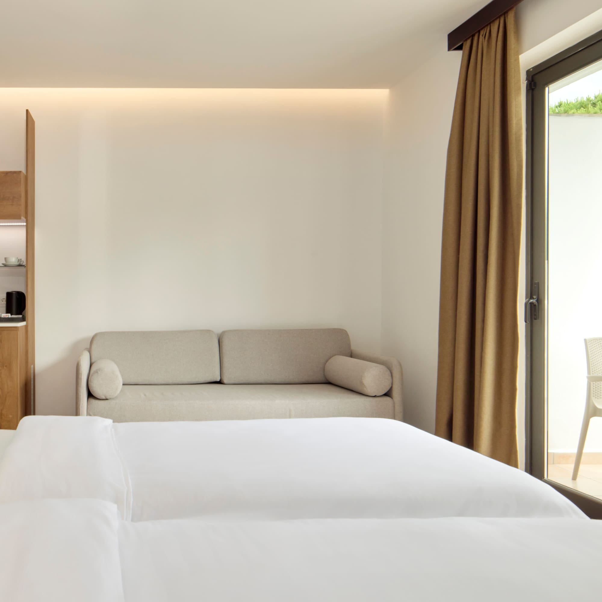 a room with two beds and a couch