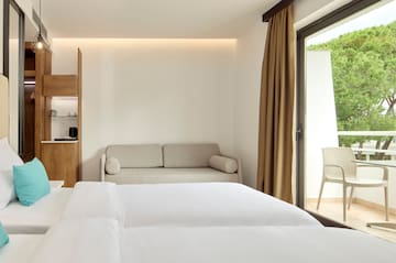 a room with two beds and a couch