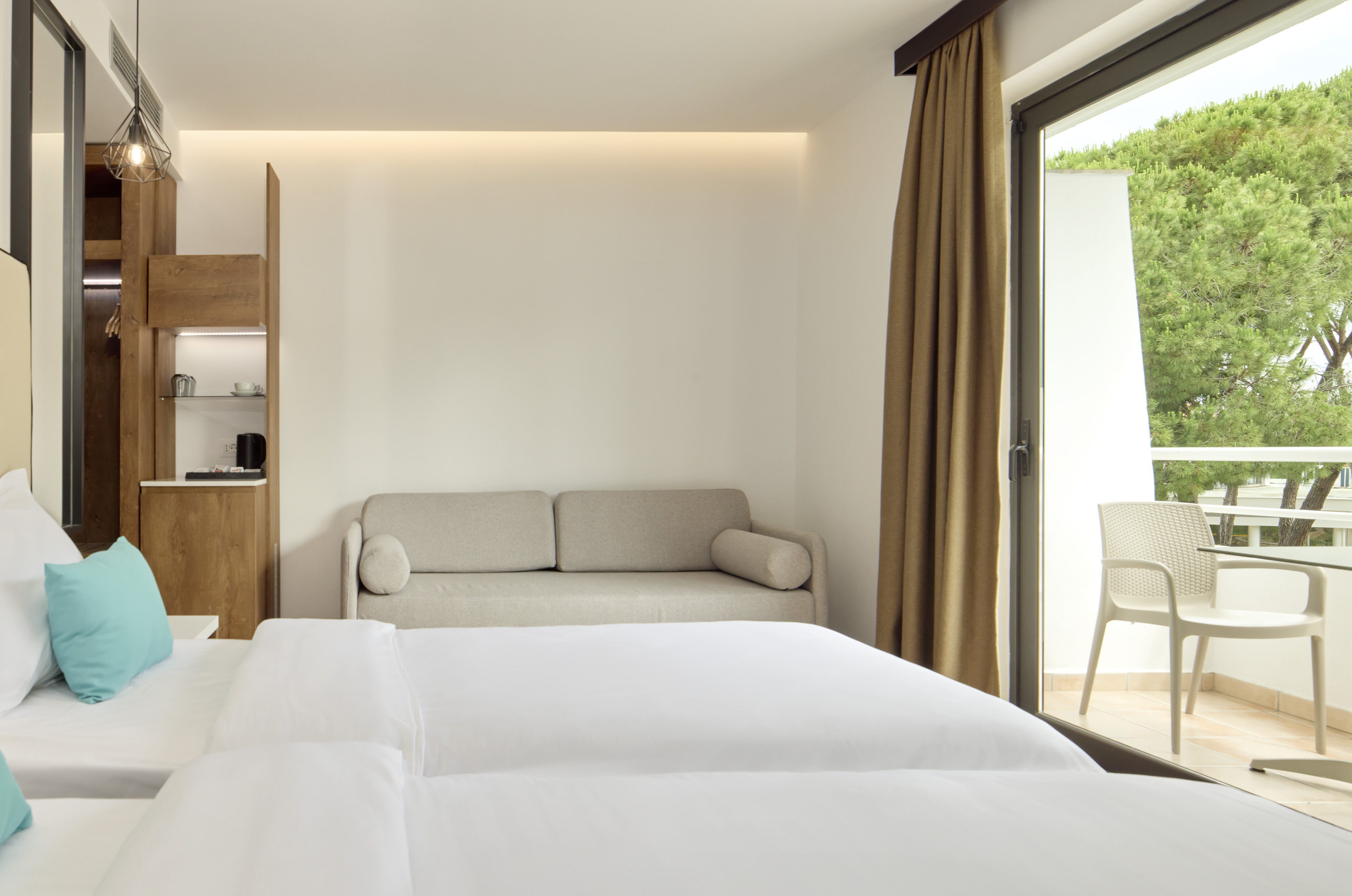 a room with two beds and a couch