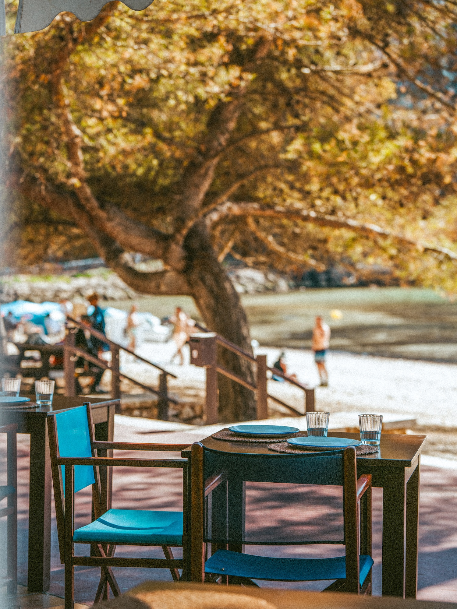 a table and chairs on a beach