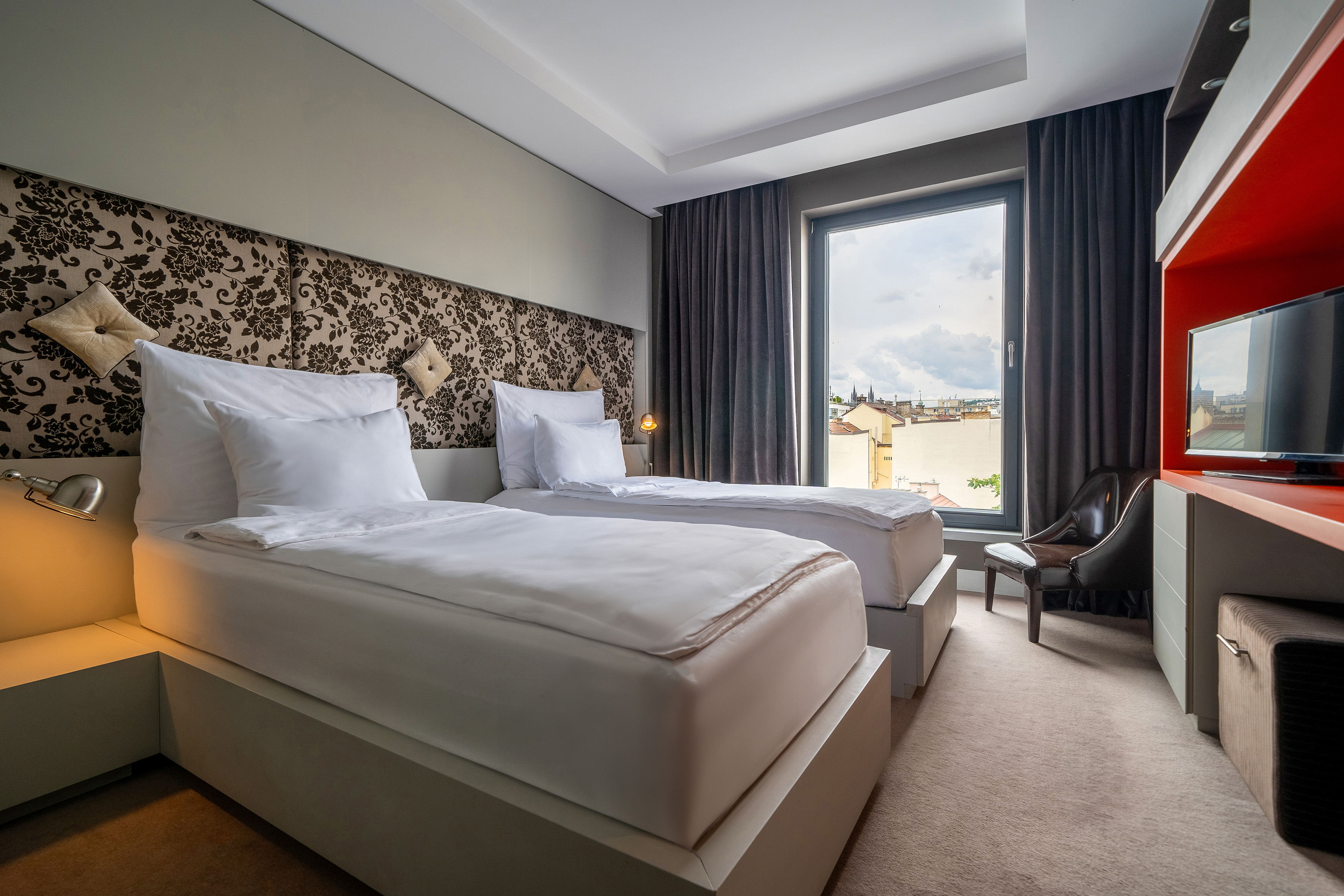 a room with two beds and a chair
