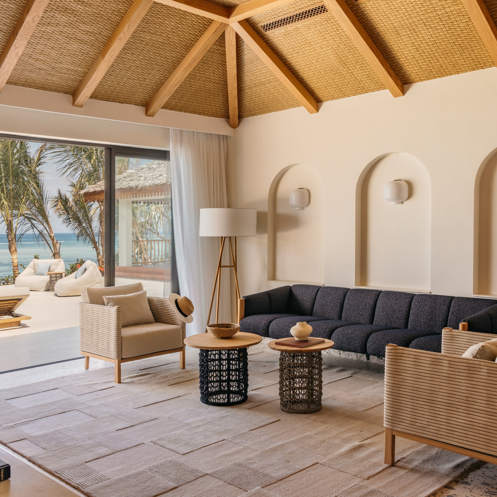 a living room with a large window overlooking the ocean
