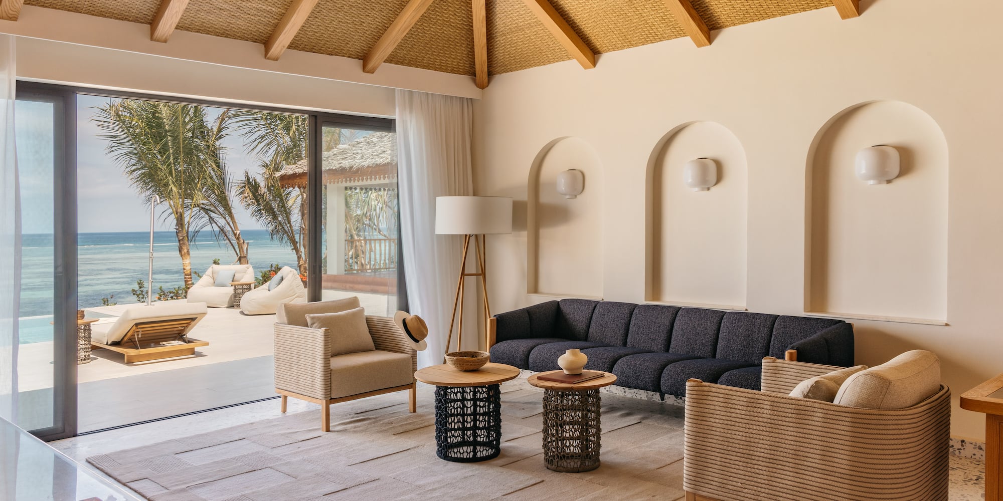 a living room with a large window overlooking the ocean